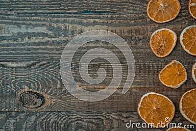 Christmas top view over a brown wooden background with dryed oranges placed from right side of a table. Flat lay, copy Stock Photo
