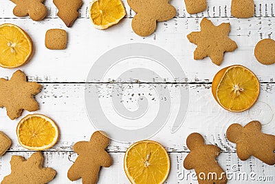 Christmas top view over a white wooden background with christmas cookies and dryed oranges. Flat lay, copy space, holiday banner. Stock Photo