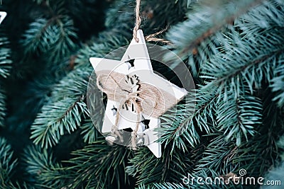 Christmas toy on the branches of a New Year tree. Christmas tree decorated with wooden handmade Stock Photo