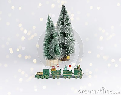 Christmas toy train and tiny fir trees among garland lights. Composition for postcard Stock Photo