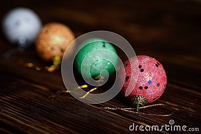Christmas toys - four multi-colored balls on a dark Stock Photo