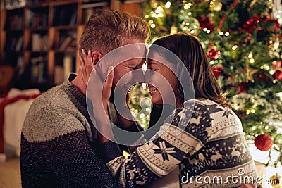Christmas tradition - Cheerful couple enjoying together on Chris Stock Photo