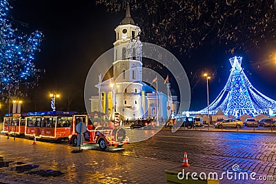 Christmas train and Christmas tree at Cathedral Square in Vilnius at night Editorial Stock Photo