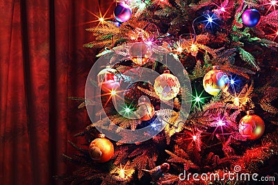 Christmas tree with balls, glowing garland and tinsel Stock Photo