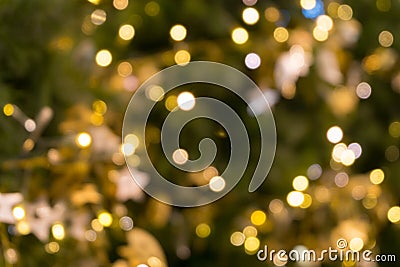 Christmas tree bokeh light in green yellow golden color, holiday abstract background, blur defocused Stock Photo