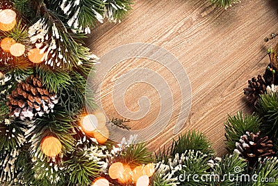 Christmas tree branch wreath with blue and green baubles and golden defocused lights on wooden background Stock Photo