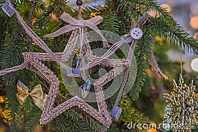 Christmas tree is decorated with beads and a star. Multi-colored garlands on a blurry background. Happy New Year Stock Photo