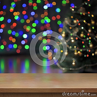 Christmas tree decorated behind empty wood table or shelf Stock Photo