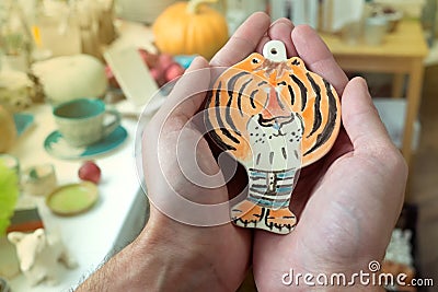Christmas tree decoration tiger on hand. Symbol of the year 2022 Stock Photo