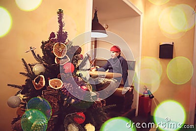 Christmas tree decorations in a cafe where a young man rests Stock Photo