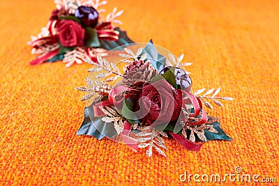 Christmas tree decorations with rose and cherry on orange hessian. Stock Photo