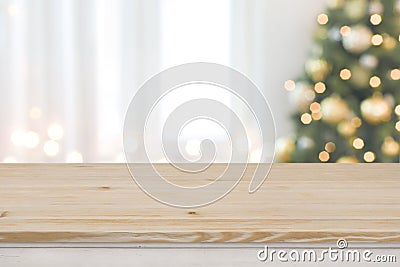 Christmas tree defocused background with wooden table in front Stock Photo