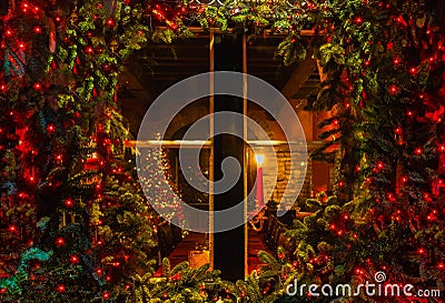 Christmas tree and fireplace seen through a wooden cabin window Stock Photo