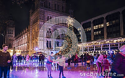 Christmas tree and ice skating rink at night outside the Natural History Museum Editorial Stock Photo