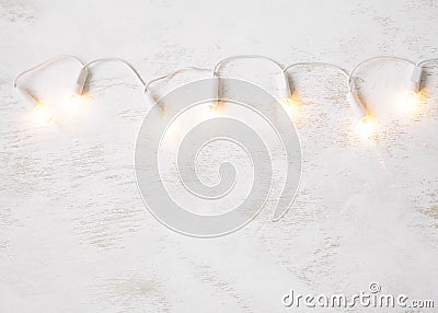 Christmas tree lights on white shabby background. Stock Photo