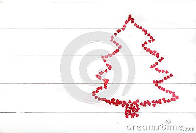 The Christmas tree is lined with an outline of red glittering hearts. Holiday concept Stock Photo