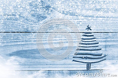 Christmas tree made from dry sticks on wooden, blue background. Snow and snow flaks image. Christmas tree ornament with star. Stock Photo