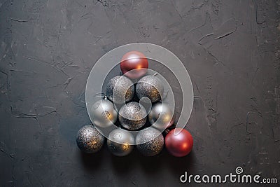 Christmas tree made by silver and pink Christmas balls on the dark background, copy space Stock Photo