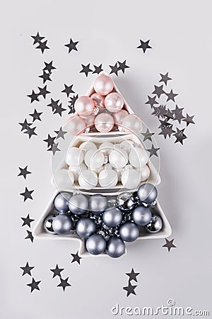 Christmas tree made of silver pastel balls on grey Stock Photo