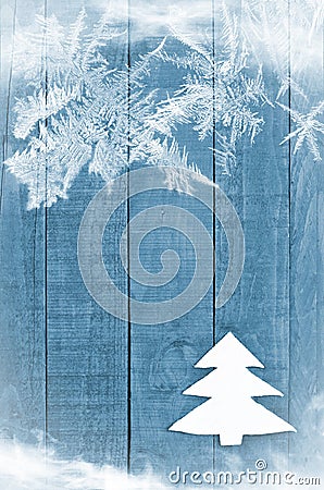 Christmas tree made from white felt on wooden, blue background. Snow flaks image. Christmas tree ornament, craft Stock Photo