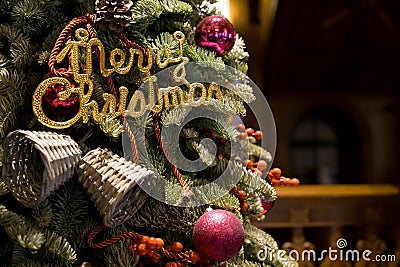 A Christmas tree with Merry Christmas greeting sign Stock Photo