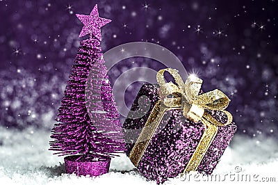 Christmas tree, purple gift with a gold bow Stock Photo