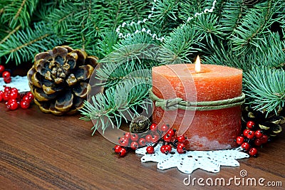 Christmas tree, red berries and cones,With a burning candle. Stock Photo