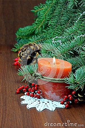 Christmas tree, red berries and cones,With a burning candle. Stock Photo