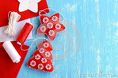 Christmas tree and star made of felt on a blue wood background with blank space for text. Handmade Christmas toys Stock Photo