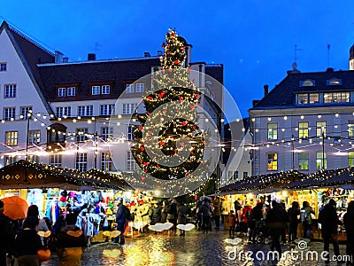 Christmas tree on Tallinn old town hall square market place shopping city evening decoration people walking street in medieval t Editorial Stock Photo