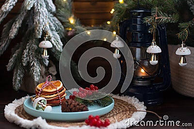 A Christmas tree with toys and a plate with red viburnum berries and orange slices. Stock Photo