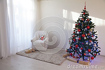 Christmas tree in a white room for Christmas with gifts Stock Photo