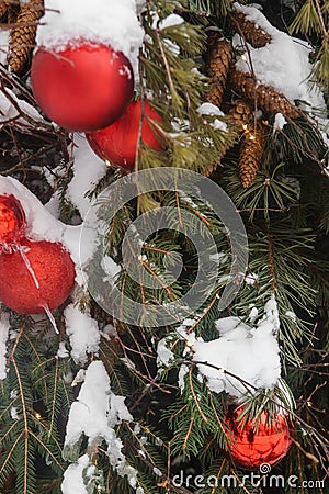 Christmas trees decorated with red balloons in front of the cafe entrance. Street Christmas decorations. Stock Photo