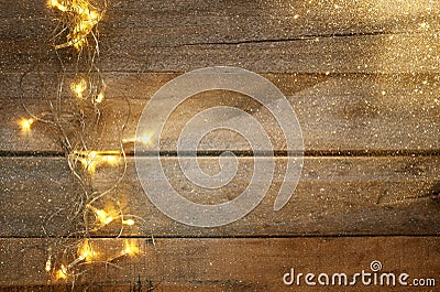 Christmas warm gold garland lights on wooden rustic background Stock Photo