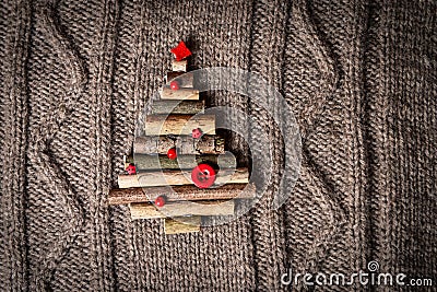 Christmas warm knitted background with new year tree decorations made of sticks. Vintage christmas card with handmade christmas tr Stock Photo