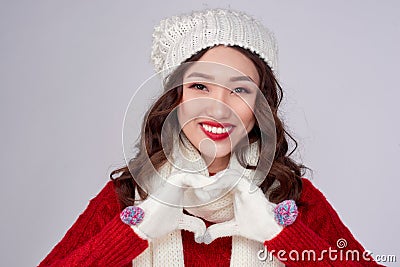 Christmas winter happiness concept. Asian woman wearing winter clothing giving heart shape Stock Photo