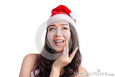 Christmas Woman. Beauty Asian Model Girl in Santa Hat Thinking S Stock Photo