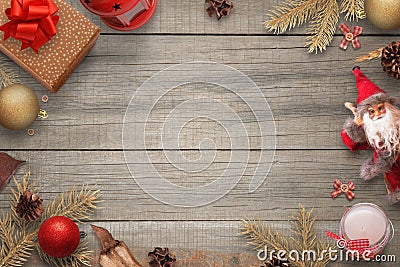 Christmas wooden background with Christmas decoration, fir branches, gifts, Santa doll, candle, balls, lantern Stock Photo