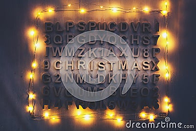 Christmas word made of wooden letters among other random letters Stock Photo