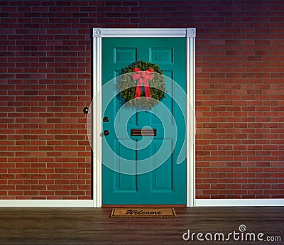Christmas wreath on blue front door with welcome mat. Stock Photo