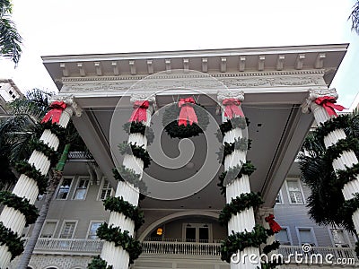 Christmas Wreath and Decorations with Red Bows hang from The Moana Hotel Editorial Stock Photo