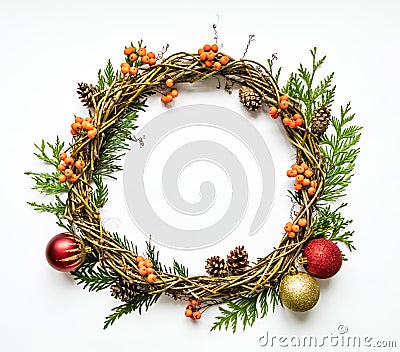 Christmas wreath of vines with decorative ornaments, thuja branches, rowanberries and cones. Flat lay, top view Stock Photo