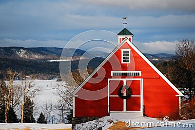 A Christmas wreath hands on a New England barn Stock Photo