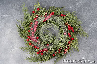 Christmas Wreath Made of Naturalistic Looking Pine Branches Decorated with Winter Berries Stock Photo