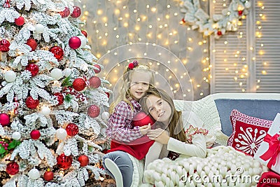 Christmas xmas casual gold studio decorations with cute girl and huge mirror with golden frame plenty presents and big green pine Stock Photo