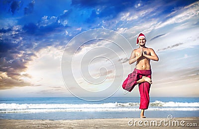 Christmas yoga on the beach Stock Photo