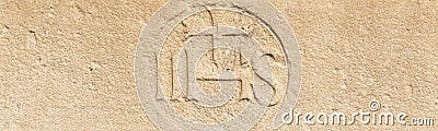 Christogram IHS monogram symbolizing Jesus Christ on stone wall Stock Photo