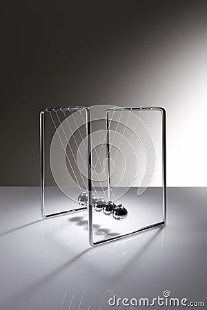 Chrome balancing spheres know as Newton's Cradle Stock Photo