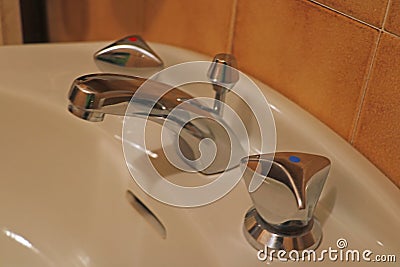 Chrome bathroom faucet. Bathroom water tap. Old faucet. Bathroom interior. Out of focus Stock Photo