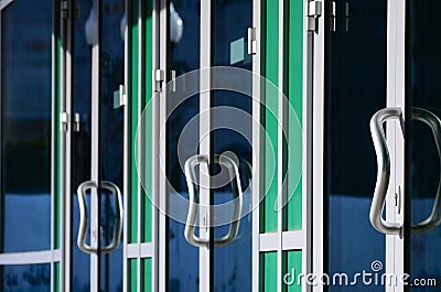 Chrome door handle and glass of modern aluminium office facade Stock Photo